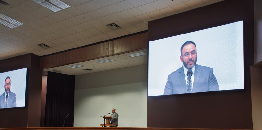 Professional videographer filming a corporate conference event